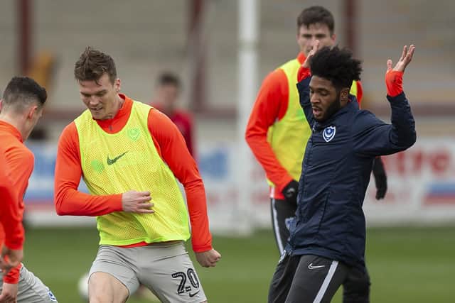 Ellis Harrison (far right) warming up before Pompey's match at Fleetwood - but he soon pulled out of the game following a reaction to his dead leg. Picture: Daniel Chesterton/phcimages.com