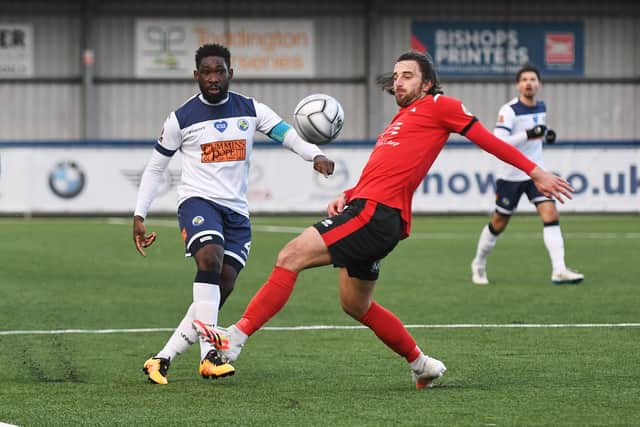 Godfrey Poku in action alongside Eastbourne Borough's two-goal match-winner Chris Whelpdale. Picture: Neil Marshall
