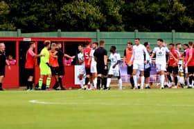 Harvey Bradbury (centre) has taken his Gosport shirt off and is about to leave the pitch after being sent off in yesterday's pre-season friendly at Fareham. Picture by Tom Phillips