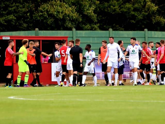 Harvey Bradbury (centre) has taken his Gosport shirt off and is about to leave the pitch after being sent off in yesterday's pre-season friendly at Fareham. Picture by Tom Phillips