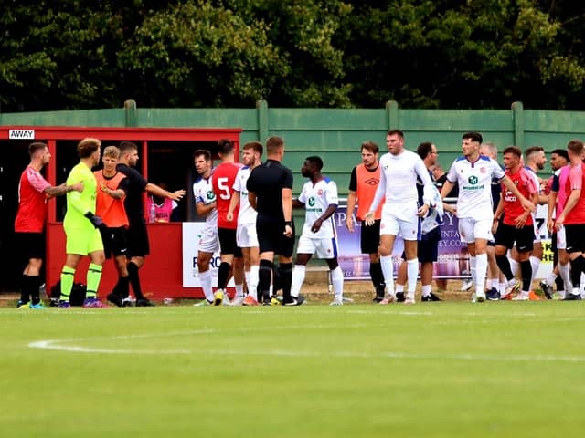 Harvey Bradbury (centre) has taken his Gosport shirt off and is about to leave the pitch after being sent off in yesterday's pre-season friendly at Fareham. Picture by Tom Phillips