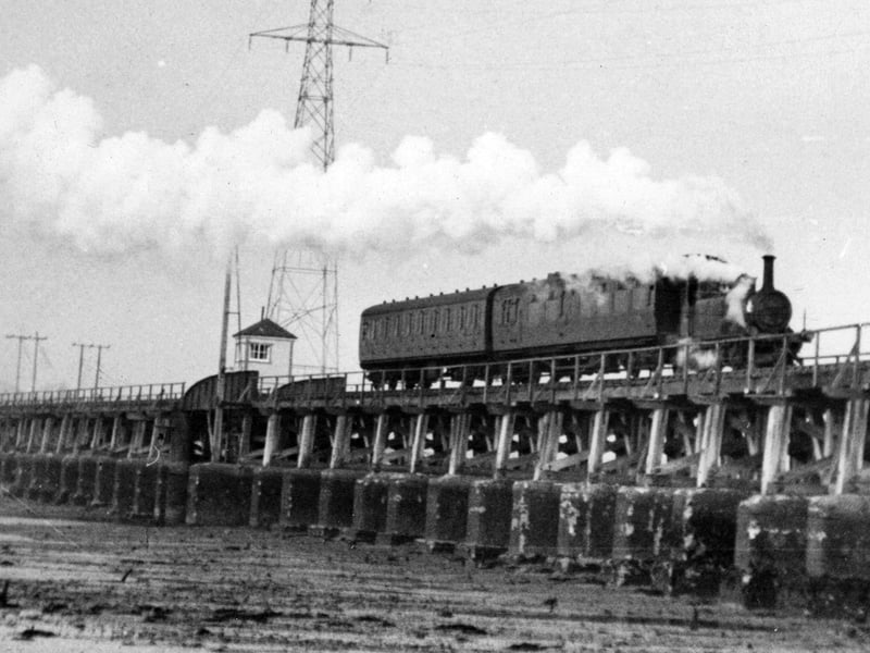 The Hayling Billy crosses Langstone Harbour at low tide.