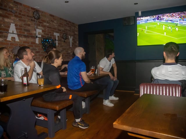 England fans watching the start of the match against Senegal. Photos by Alex Shute