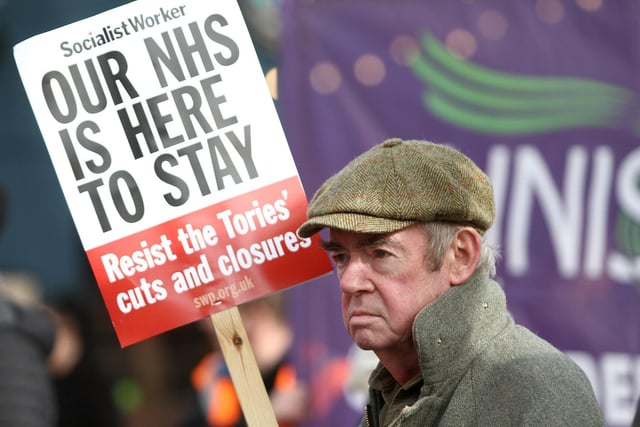 Scores of placard-waving protesters attended.