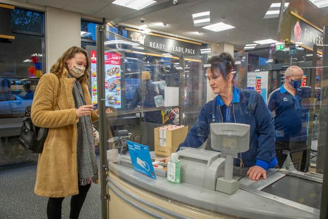Staff member Francis Harris serving a customer at the Aldi Store, Gamble Road, Portsmouth.
Picture: Habibur Rahman