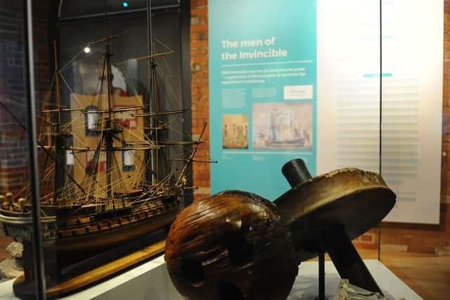 Lost artefacts on display next to a model of HMS Invincible 
Picture: Sarah Standing (221020-6265)