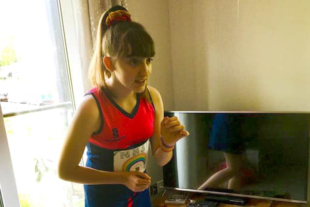 Jelly Netball Club member Holly Corkett running in her front room