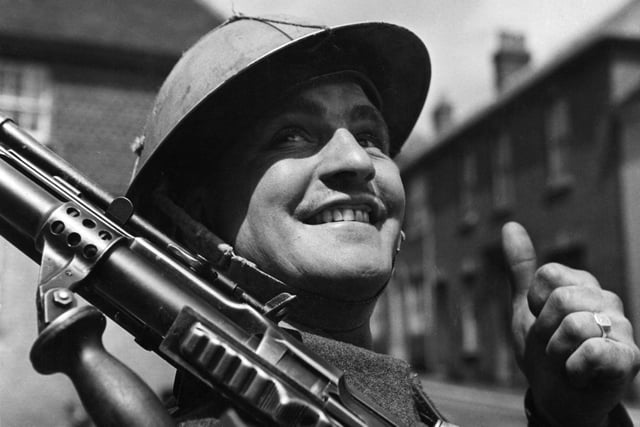 6th June 1944:  A British soldier, encamped in a small English village, gives the thumbs-up as he awaits his orders for D-Day.  (Photo by Fox Photos/Getty Images)