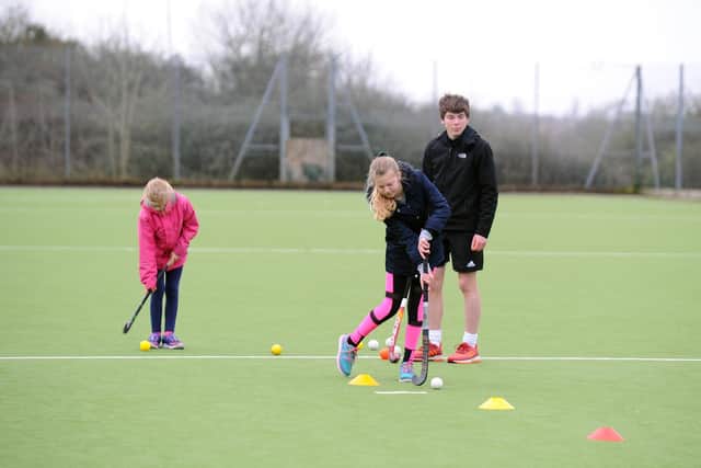 Sisters Scarlett Featherstone, eight,  left, and Summer Featherstone, 11, having a go at hockey.
Picture: Sarah Standing (210220-5961)