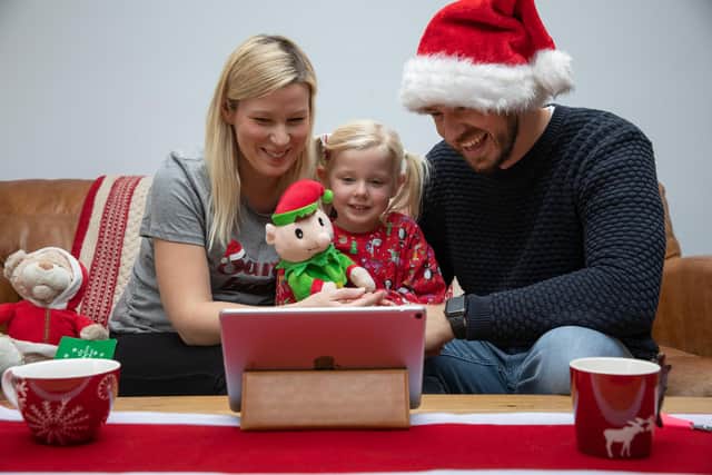 Simon Jenns, who has set up livevideosanta.com, with his daughter Lexi and wife Jo in their Denmead home. Picture from Steven Stringer. 