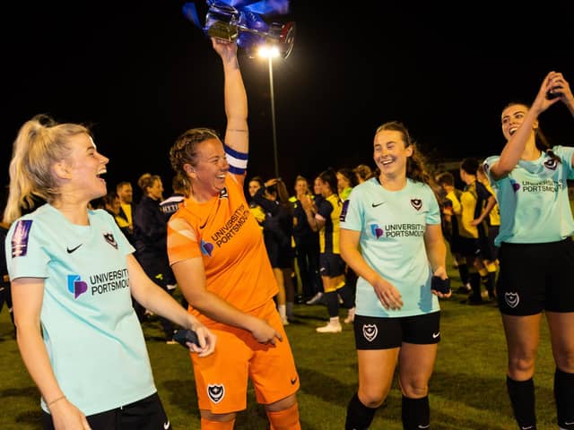 Portsmouth captain Hannah Haughton lifts the Portsmouth & District FA Senior Women's Cup. Picture by Alex Shute