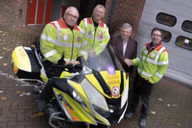 Chair Robert Smith on the bike. Next to him is Steve Luckett (Dave Luckett's son), Dave Luckett, and Tim Bennett, trustee and treasurer.