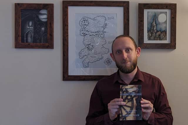 Budding author, Damien Tiller, 33, with a copy of his new book, A Tailor's Son.