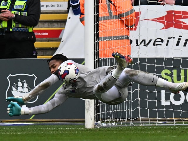 Pompey goalkeeper Josh Oluwayemi pulls off a first-half save against Plymouth at Home Park. Picture: Graham Hunt/ProSportsImages