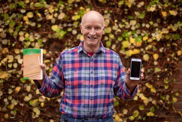 Alan Pilcher with his book, and the iPhone he wrote it on. Picture: Habibur Rahman