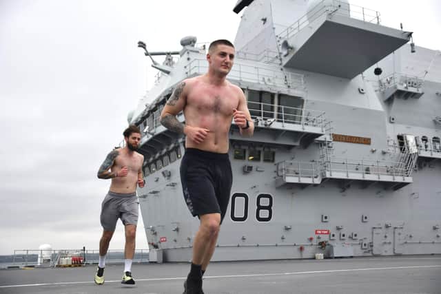 Pictured here are LAE Dee and AE Azsairi who ran a marathon on the flight deck of HMS Queen Elizabeth.  Photo: LPhot Luke
