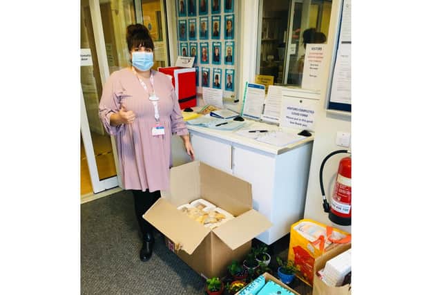 A staff member from Shearwater Care Home accepting presents from the Christmas Pompey Present project in December 2020