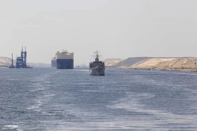 HMS Middleton leads a line of heavy traffic passing through Suez