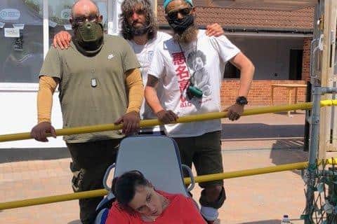 Rear: Robert Crandon, 34, and Harry Carney, 35, and Andrew Hughes after completing their epic three-day "bike and hike" from London to Wickham. They are pictured with Andrew's sister, Sarah Coller, who has Huntington's Disease.
Picture: Sam Stephenson