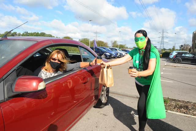 Staff at Wellington Vale Care Home in Waterlooville, dressed up as superheroes and served cake and coffee in a drive thru coffee morning for Macmillan Cancer Research on Friday, September 25.
Pictured is: Jackie Moore from Denmead with Breda O'Doherty, activities manager at Wellington Vale.
Picture: Sarah Standing (250920-4548)