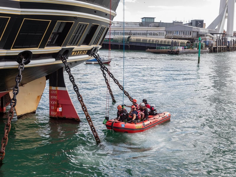 Firefighters practicing rescue from the sea, ascending by rope onto HMS Warrior during the UKRO event at Portsmouth Historic Dockyard. Picture: Mike Cooter (280924)