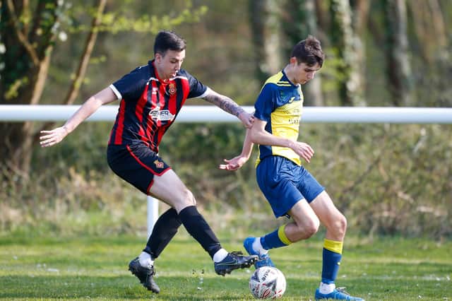 Fleetlands' Brandon Rogers, left, in action against former club Moneyfields during last weekend's win that took Fleetlands into the top three of the Hampshire Premier League's Senior Division. Picture by Dave Bodymore
