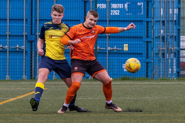 Action from the 2-2 draw between the under-18s of Moneyfields (blue/yellow kit) and AFC Portchester (orange/black kit). Picture: Mike Cooter