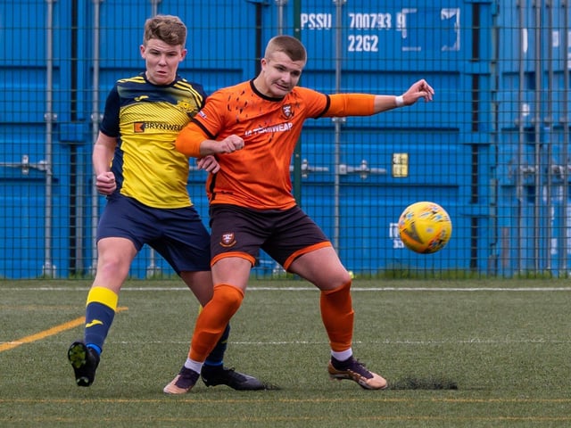 Action from the 2-2 draw between the under-18s of Moneyfields (blue/yellow kit) and AFC Portchester (orange/black kit). Picture: Mike Cooter