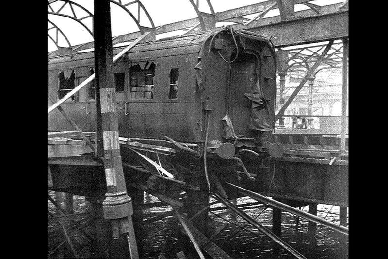 Carriage hanging off the rails. During the air raid of January 10, 1941, Portsmouth Harbour station was wrecked. Picture: T. Bye collection.