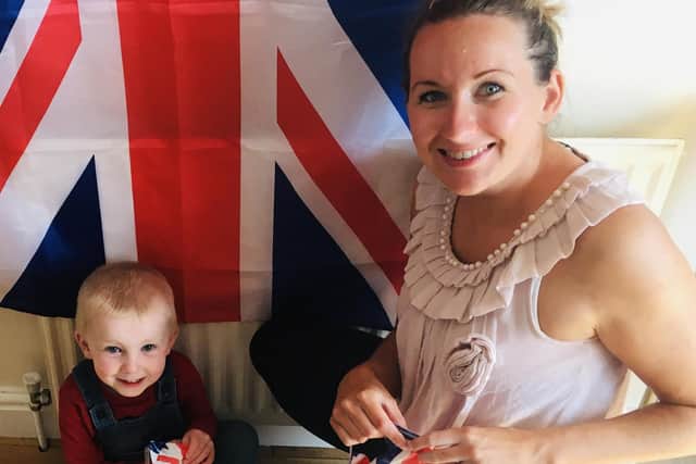 Ashley Billinghurst is helping stage a similar celebration in Elmhurst Road and Belvoir Close. Her she is pictured with her child as they prepare bunting and leaflets.