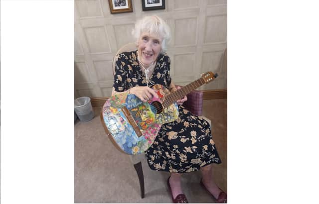 Cathy Barnett with her guitar 
Picture: Care UK