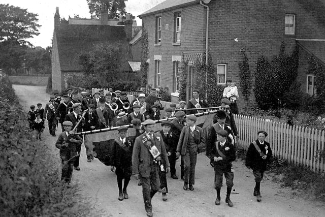 Villagers marching down Five Heads Road, Horndean, over 100 years ago.