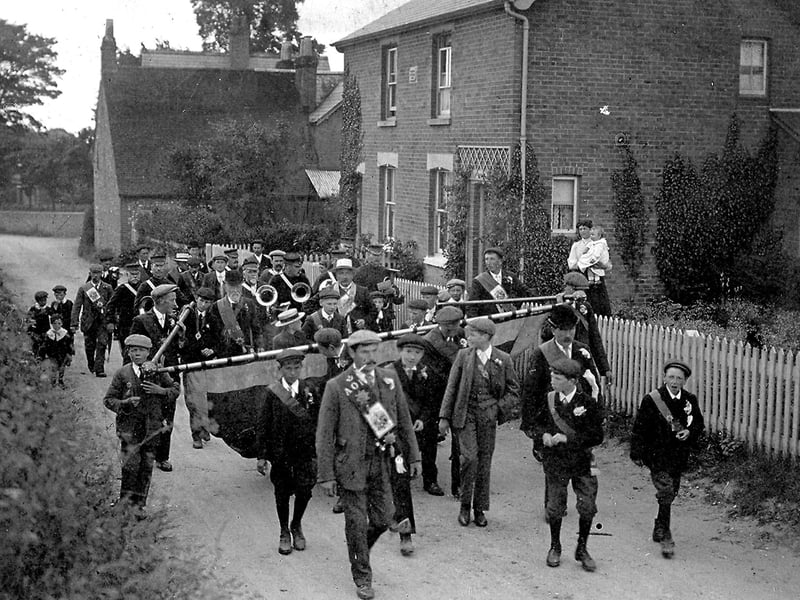 Villagers marching down Five Heads Road, Horndean, over 100 years ago.