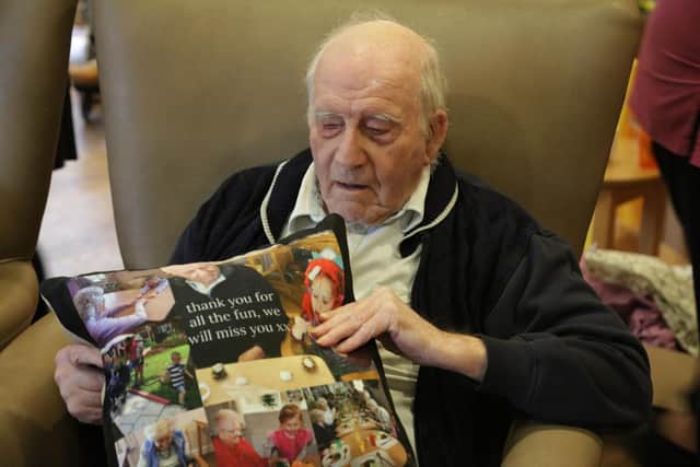 Children from Growing Places nurseries visited their friends at local nursing homes to give them gifts just before lockdown. Pictured: Les from Woodlands Care Home with one of the cushions created by the kids