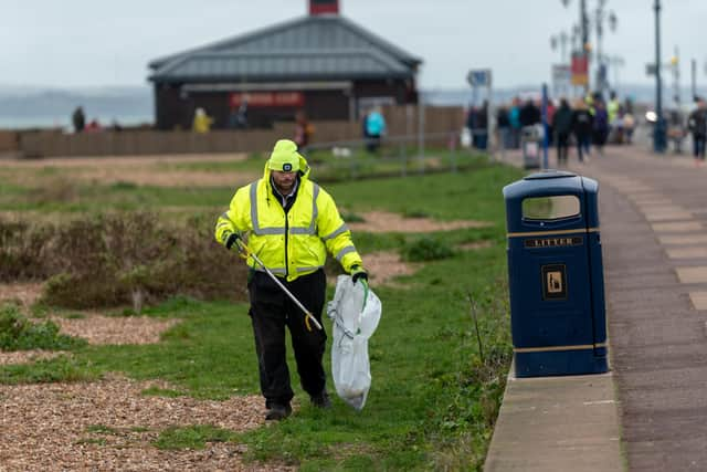 Eastney Beach Clean - Richard Allison cleans the beach with the Coffee Cup in the background.
Picture: Vernon Nash (040120-001)