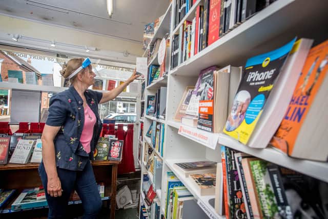 Marie Telford placing a book into the shelf at The Hayling Island Book Shop. Picture: Habibur Rahman