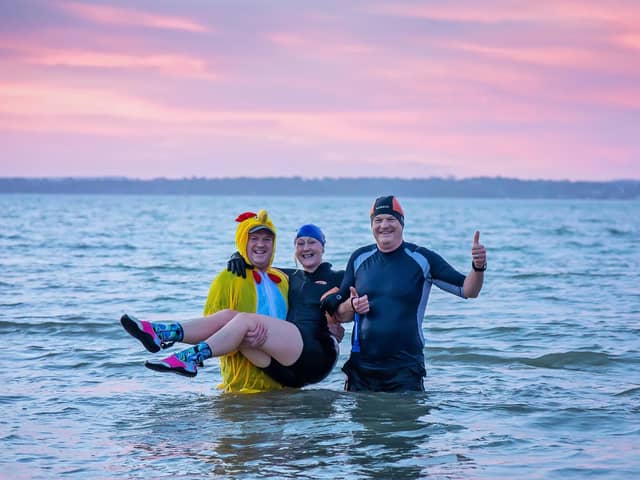 Timothy Angel (48), Meryl Walker (57) and Jonnie Angel (56) from #Vitamin_Sea_Gosport during their dawn swim at Stokes Bay. Picture: Mike Cooter (010122)