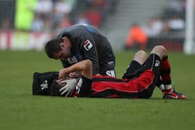 Former Bournemouth physio Steve Hard, pictured treating Michael Symes in October 2011, has this week joined Pompey as head of medical. Picture: Pete Norton/Getty Images