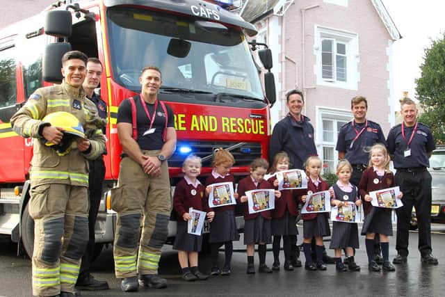 Firefighters with pupils from the nursery class.