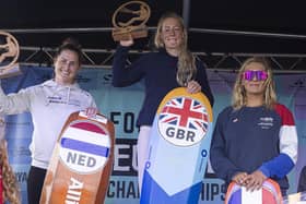 Ellie Aldridge atop the podium on Eastney Beach after winning the female European kitefoil championship title. Picture by Lloyd Images