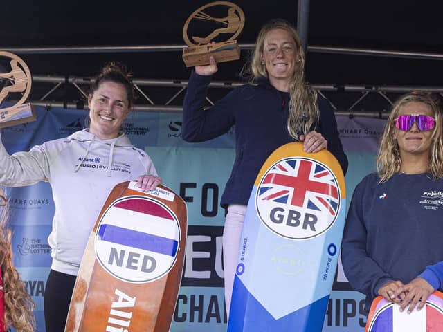 Ellie Aldridge atop the podium on Eastney Beach after winning the female European kitefoil championship title. Picture by Lloyd Images