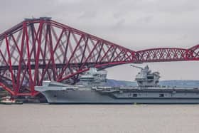 HMS Queen Elizabeth makes her way under the Forth Bridges. 