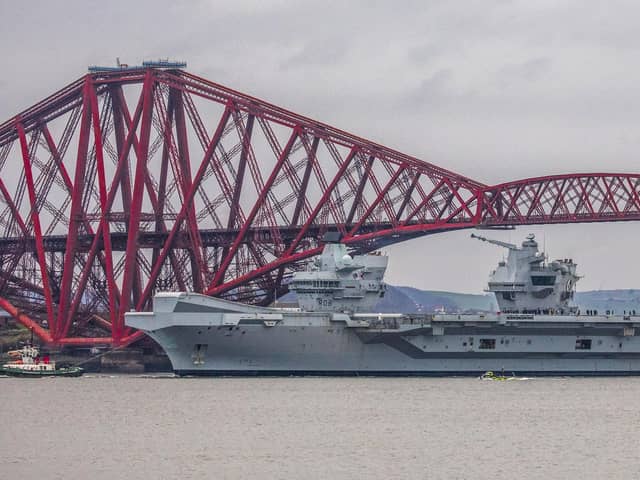 HMS Queen Elizabeth makes her way under the Forth Bridges. 