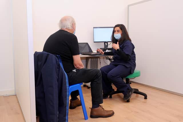 Mita Thakrar, superintendent at Greywell Pharmacy, speaking to a patient before the vaccination.

Picture: Sarah Standing (040221-2242)
