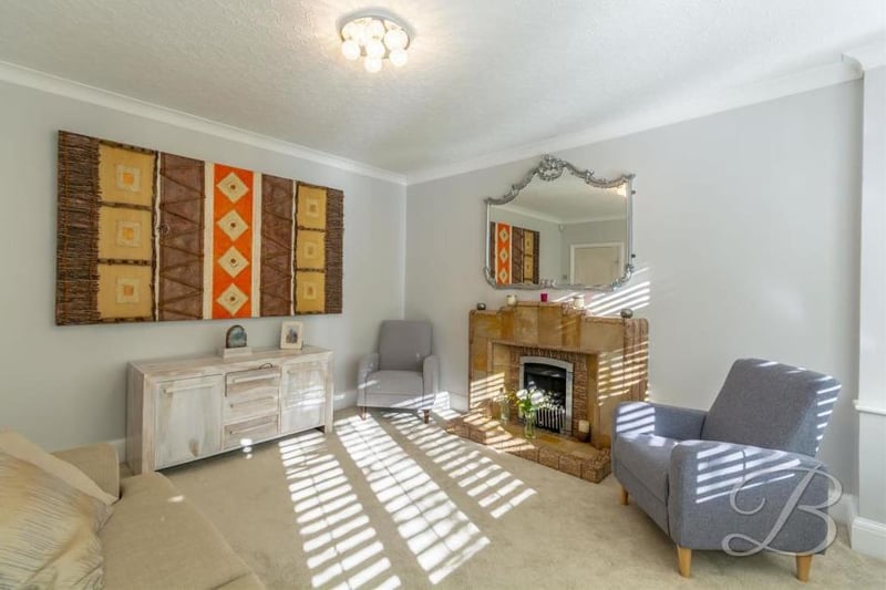 The living room is a pleasant place to spend the evening after a hard day at work. It has a carpeted floor, a central-heating radiator, feature fireplace and double doors leading outside.