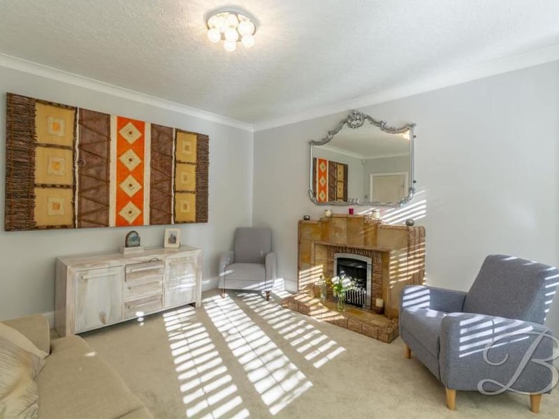 The living room is a pleasant place to spend the evening after a hard day at work. It has a carpeted floor, a central-heating radiator, feature fireplace and double doors leading outside.