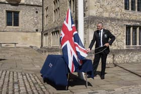 Nick Burchell raises the Union flag outside The Great Hall. Picture: HCC