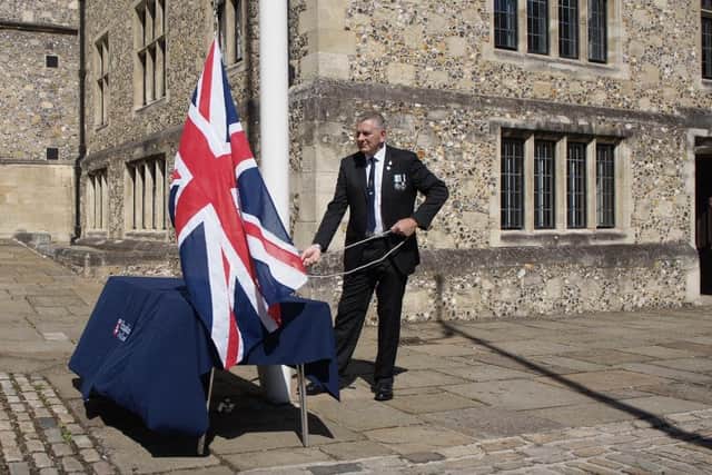 Nick Burchell raises the Union flag outside The Great Hall. Picture: HCC