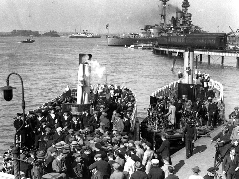 A packed Gosport ferry
In 1936 we see Dockyardmen, sailors and ordinary folk boarding and alighting two Gosport Ferries.
To the rear can be seen the railway viaduct that linked the harbour Station to the South Railway Jetty.
Tied up at the jetty is a pre-war battleship and to the left of her are two Isle of Wight paddle steamers. Picture; Courtesy of Sid Greeman.