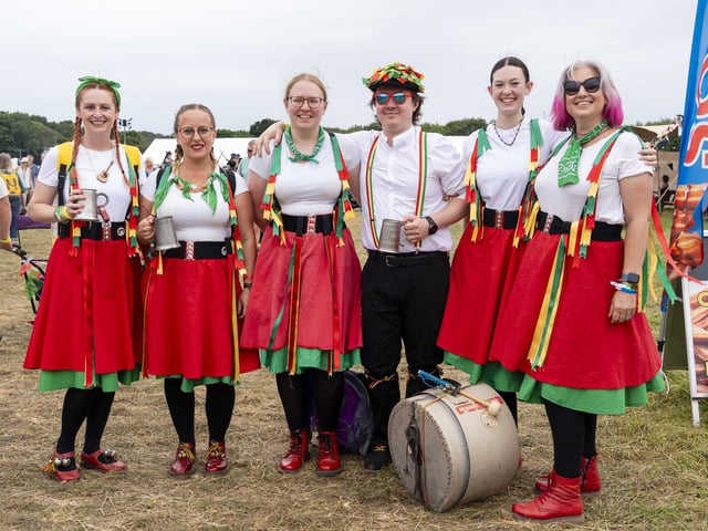 A group of Morris Dancers take a break for a drink at Wickham Festival